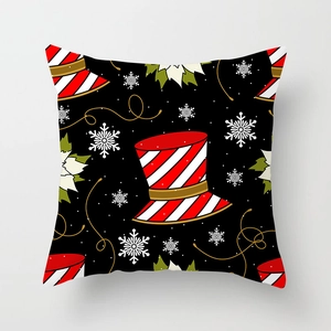 Detail of square Christmas pillowcase with black festive hat and snowflake patterns