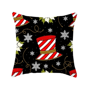 Square Christmas pillow case with black base, holiday hat, flowers and golden ribbons