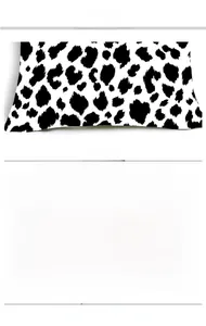 Close-up of cow print cushion cover showing dense fabric texture and high-density stitching