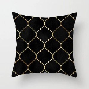 Detail of black velvet pillowcase featuring gold geometric Moroccan trellis patterns