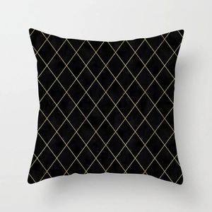 Detailed view of black geometric throw pillow case with golden embroidered diamond lattice