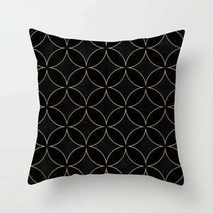 Detailed texture of black cushion cover with gold geometric leaf pattern lines