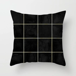 Detailed view of black and gold geometric cushion cover with artistic grid pattern texture