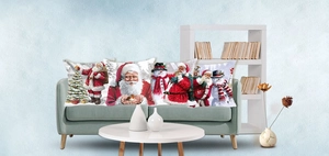 Detail of four square Christmas pillow covers with Santa and snowman prints on a sofa