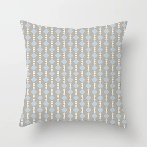 Detail of blue diamond and white dot geometric pattern on linen cushion cover