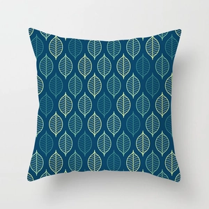 Detail of square pillowcase featuring navy geometric leaf pattern in Nordic style