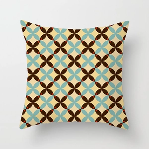 Close-up of geometric square pillowcase with vintage cross and diamond pattern on beige