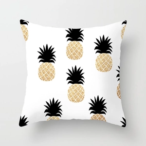 Detail of modern square pillowcase featuring gold glitter pineapple pattern on light fabric