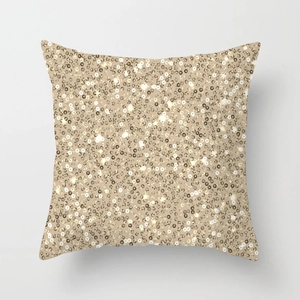 Detail shot of shimmering champagne gold sequins on a modern luxury cushion cover