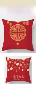Detailed view of red Lunar New Year pillow covers with golden lantern and knot patterns