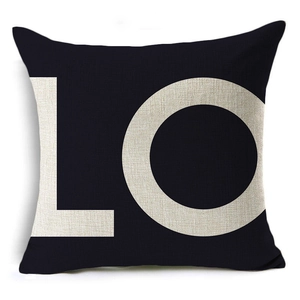 Detail of square linen pillowcase in black featuring beige LO lettering for home decor