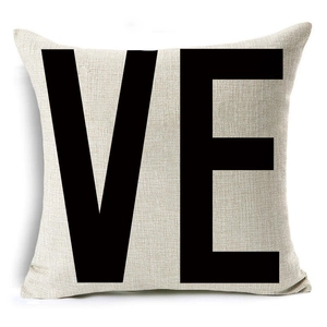 Close-up of linen pillowcase with black VE letter print and visible fabric texture