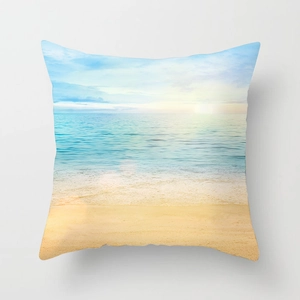 Square throw pillow featuring a scenic summer beach sunset with blue ocean and sand