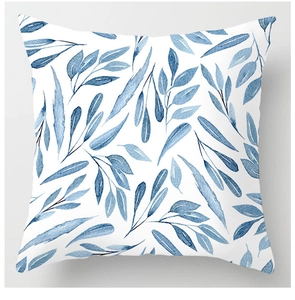 Detailed view of the watercolor blue leaf pattern on a white square cushion cover