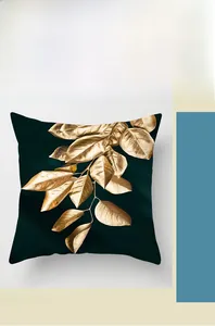 Detail of digital printed gold leaf pattern on emerald green velvet cushion cover