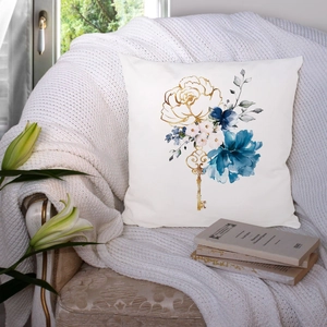 Modern blue marble pillow case with gold key and floral pattern on a cozy chair