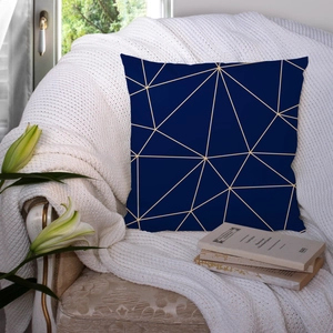 Modern navy blue geometric marble pillow case with gold triangle patterns on a chair