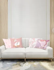 Detailed set of four decorative pink feather pillow covers on a white living room sofa