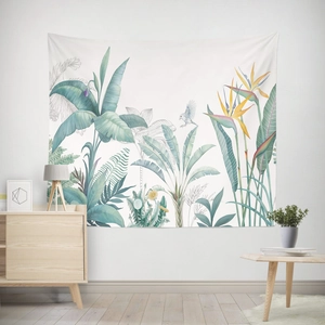 Detail of Nordic tapestry featuring tropical banana leaves and birds on a white wall