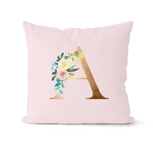 Close-up of pink pillow cover featuring a gold floral letter A and fabric texture