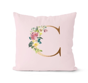 Detailed view of pink cushion cover with floral letter C print on soft fabric