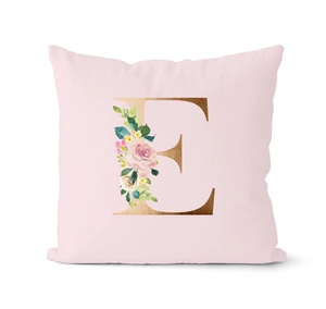 Detail of a pink square cushion cover with floral letter E design in gold foil