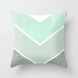 Close-up of geometric V-pattern pillow cover in mint green and white fabric texture