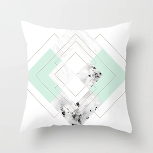 Detail of mint green geometric cushion cover featuring marble texture and golden lines
