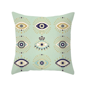 Mint green geometric throw pillow cover featuring diverse blue and gold evil eye patterns