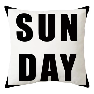 Detail of white peach skin cushion cover featuring bold black SUN DAY geometric text