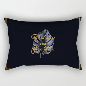 Detail of black marble lumbar pillow cover with golden Monstera leaf and art text print