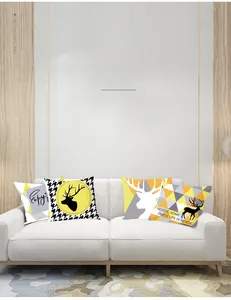Close-up of four Nordic yellow and black geometric pillow covers on a white sofa