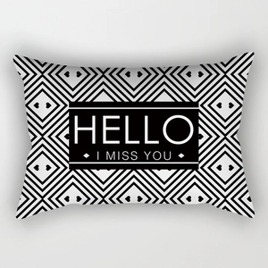 Close-up of geometric diamond patterns and HELLO I MISS YOU text on lumbar pillowcase