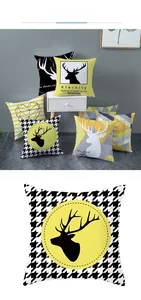 Close-up of Nordic yellow geometric cushion cover with elk and houndstooth patterns