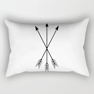 Detail of minimalist white lumbar pillow cover with black crossed arrows graphic