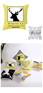 Detail of Nordic geometric cushion covers in yellow and grey with modern print patterns