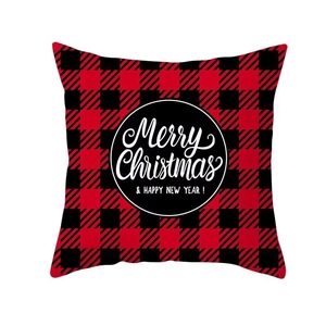 Close-up of red buffalo plaid Christmas pillow cover with Merry Christmas typography