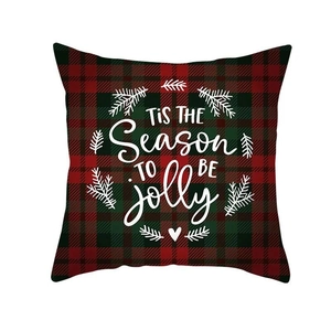 Close-up of buffalo plaid Christmas pillow cover with TIS THE SEASON TO BE jolly text