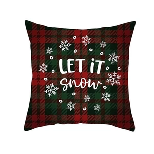 Macro detail of red buffalo plaid Christmas pillowcase with white Let It Snow print