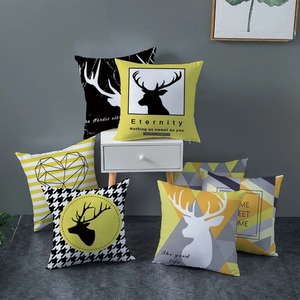 Nordic geometric pillow covers in yellow and black featuring deer and pattern designs