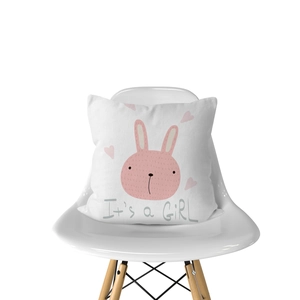 Detail of white throw pillow with pink cartoon bunny and It's a GIRL printed text