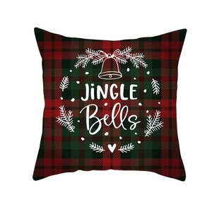 Close-up of red plaid Christmas pillowcase with Jingle Bells text and festive patterns
