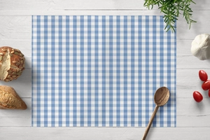 Blue gingham place mat on white wooden table with kitchen props in a lifestyle setting