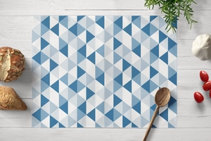 Detailed view of blue geometric triangle placemat on white wood table with ingredients