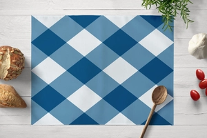 Detailed texture of blue geometric check linen placemat on a white wooden table