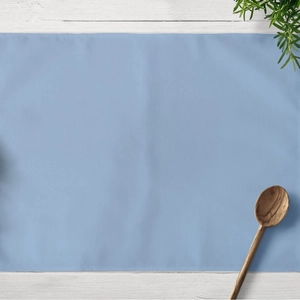 Blue geometric lattice placemat made of linen on a white wood background