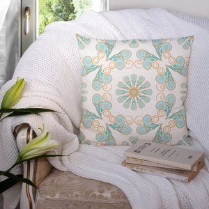 Detail of blue mandala pattern pillowcase on vintage white armchair with lilies