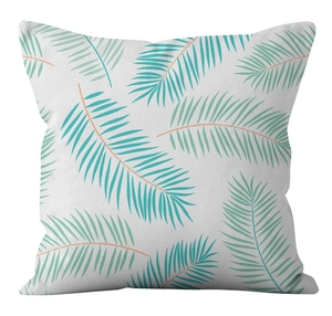 Détail des motifs de feuilles de palmier bleu sarcelle sur une housse de coussin en lin