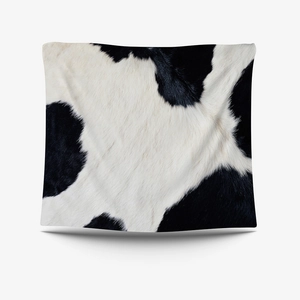 Cow print decorative tapestry with realistic faux fur texture and black white animal pattern