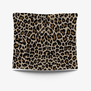 Close-up of animal print tapestry featuring classic brown and black leopard texture patterns